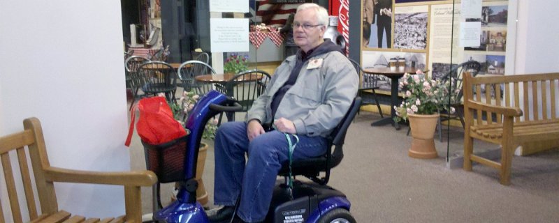 An old senior man sitting on an electrical wheel chair